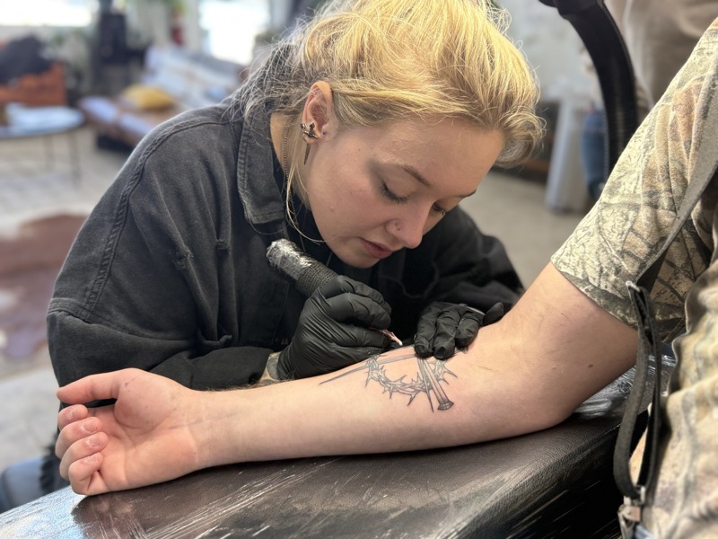 Cat Bernardy tattooing a client at Rabbit's Paw