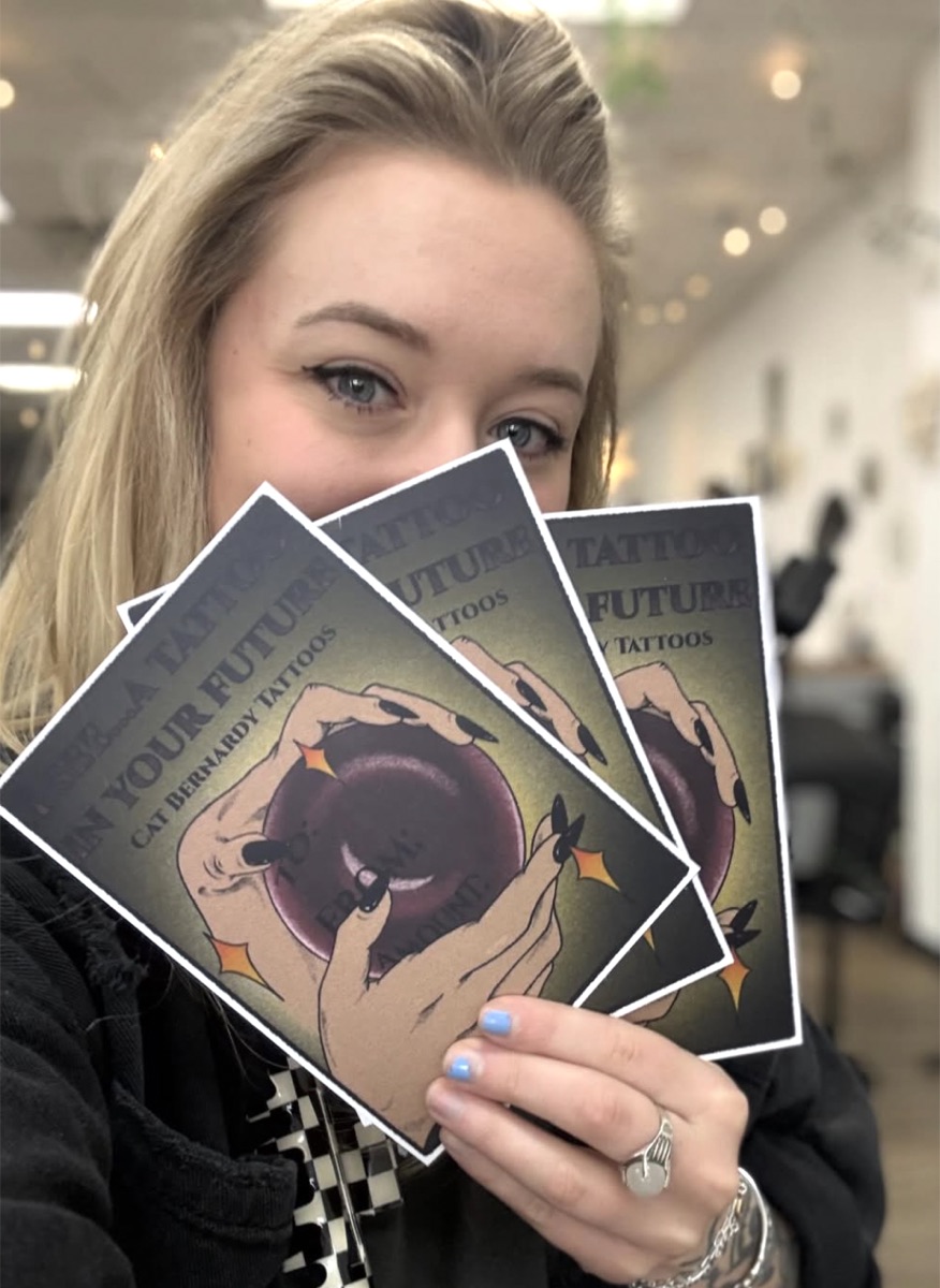 Cat with her gift certificates at Rabbit's Paw Tattoo