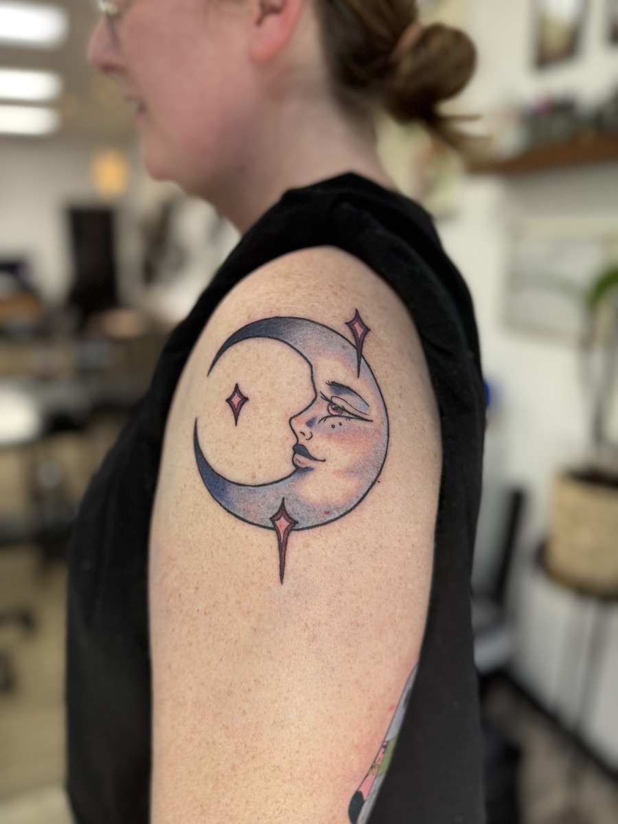 Crescent moon with a face, tattoo by Cat Bernardy