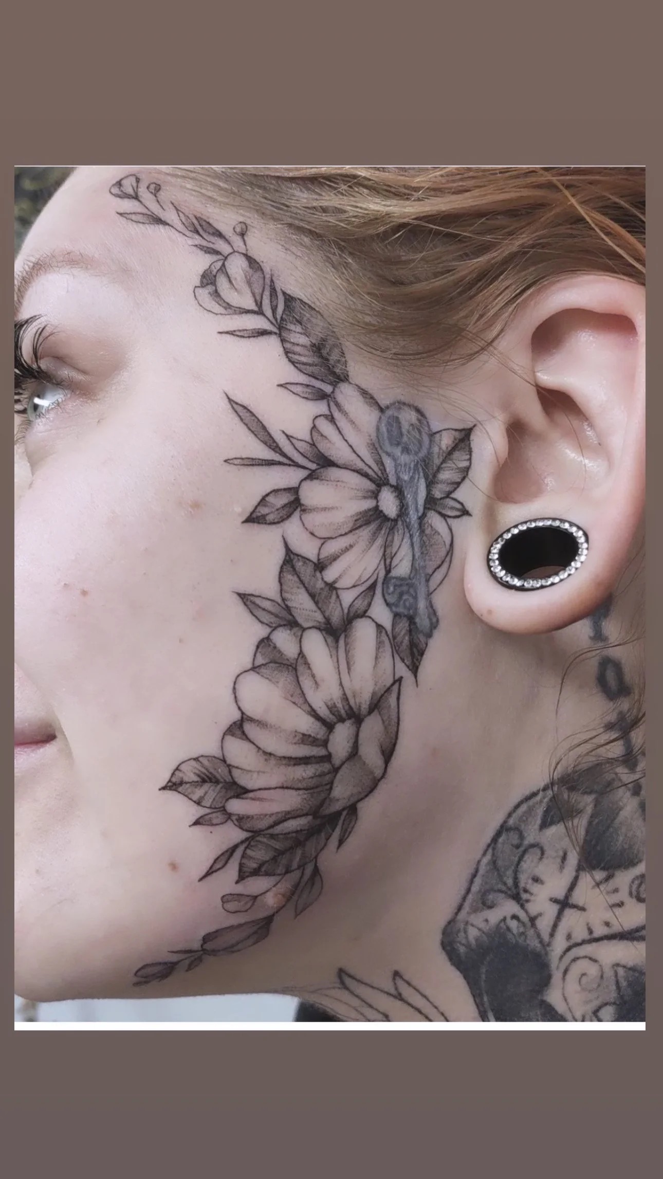 Black and grey floral face tattoo